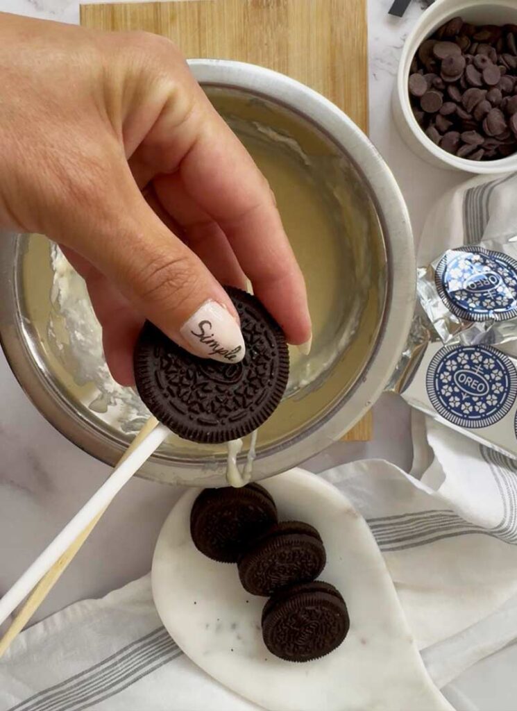 Popsicle sticks pressed into Oreos.