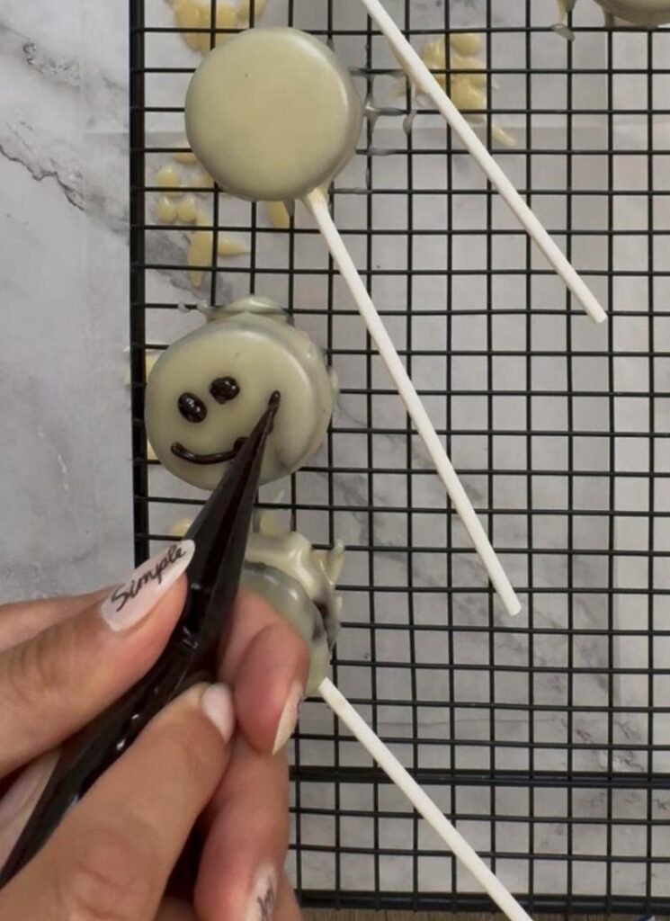 Decorating Jack’s face with dark chocolate.