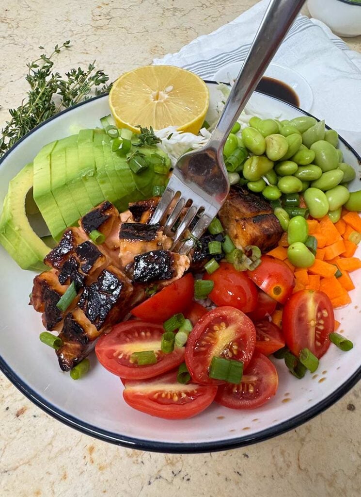 Packed with rice, fresh veggies, and protein, this salmon bowl is both nourishing and tasty.